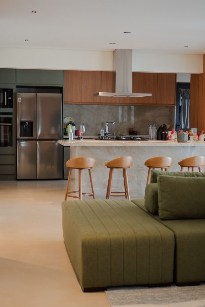 Stylish open-plan kitchen and living room interior with modern furniture and decor.