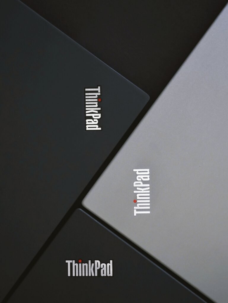 Close-up of three Lenovo ThinkPad laptops angled stylishly. Modern and sleek product photography.